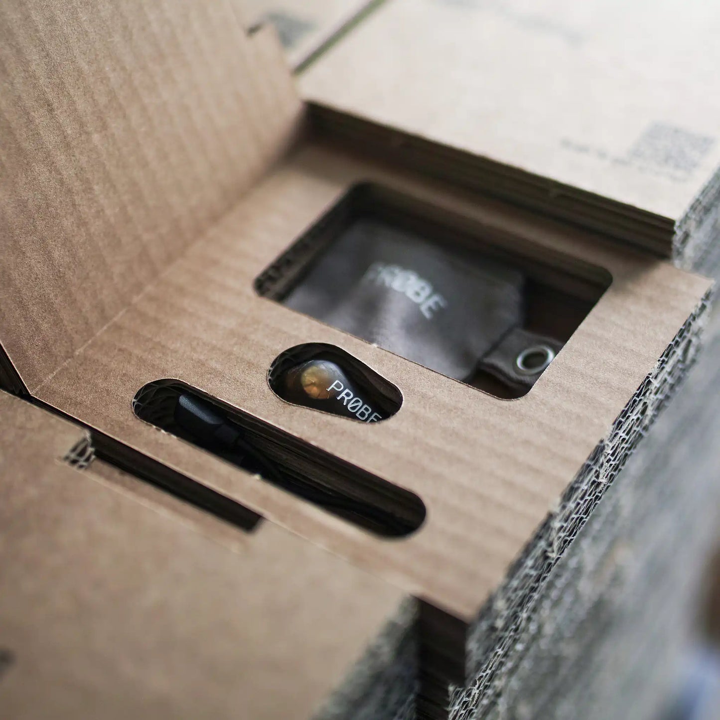 Close-up of the opened cardboard box with a PROBE inside.